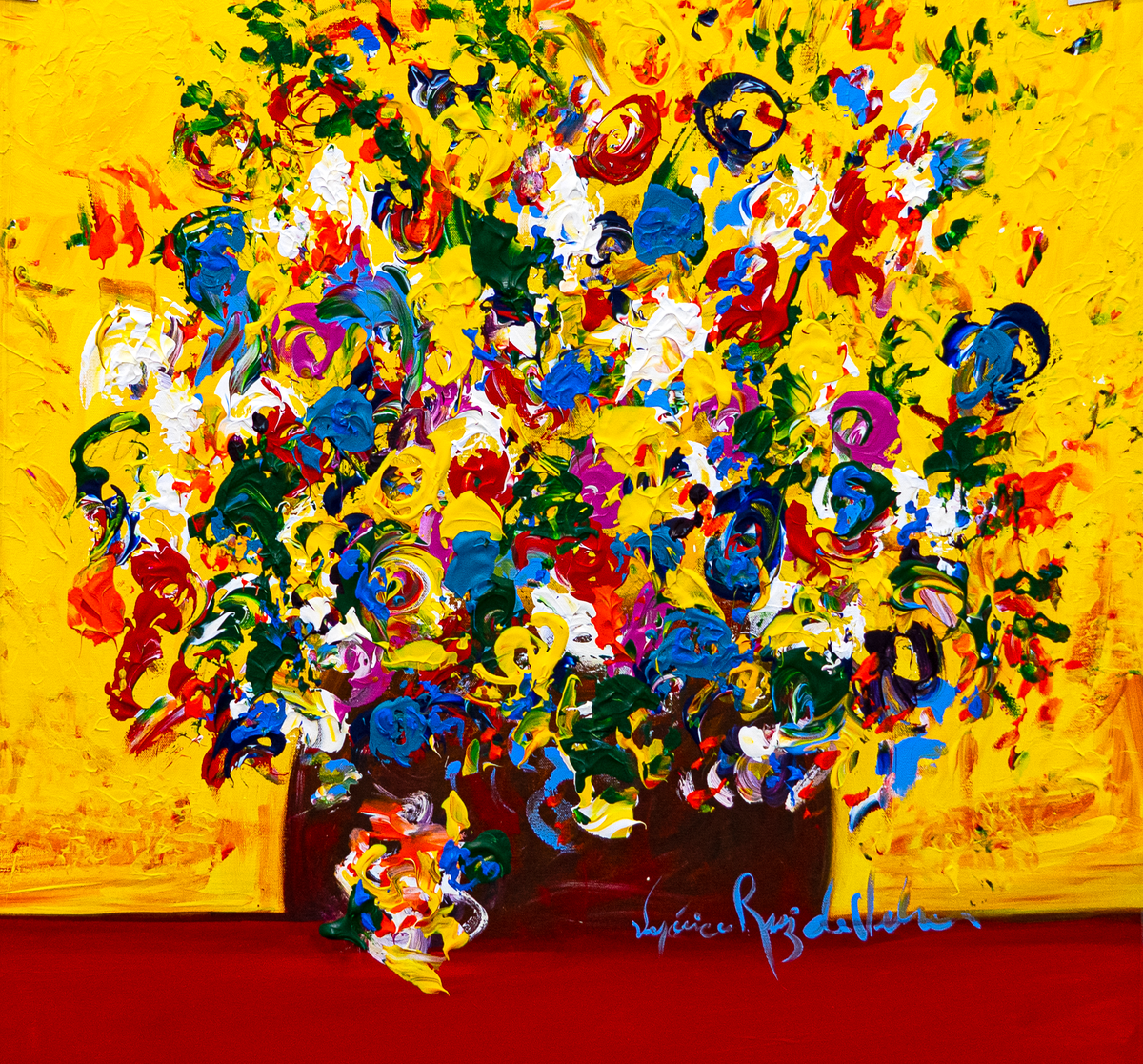 Flowers 2020 — by Veronica Ruiz de Velasco: a dense bouquet of red, white and blue blooms in a dark brown vase on a red table against a yellow wall
